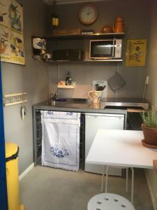 a kitchen with a table and a microwave at Het Pulletje in Westzaan