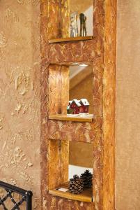 a mirror with a wooden frame with a house on it at Center Сozy in Vinnytsya
