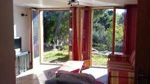 a living room with a sliding glass door with a view at palayson two in Le Muy