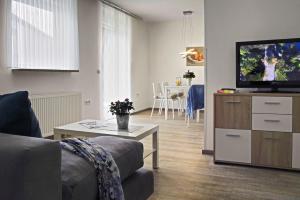 a living room with a couch and a flat screen tv at Ferienwohnungen Lippold in Bad Salzuflen