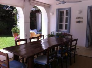 a wooden table and chairs on a patio at Villa Pitiousa in Spetses