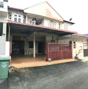 a house with a porch with a red fence at Lepak-Lepak Homestay @Alor Akar Kuantan in Kuantan