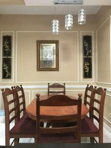 a dining room with a wooden table and chairs at Lepak-Lepak Homestay @Alor Akar Kuantan in Kuantan