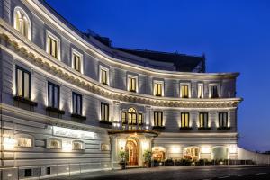a large white building with lights on it at night at Hotel Santa Caterina in Amalfi