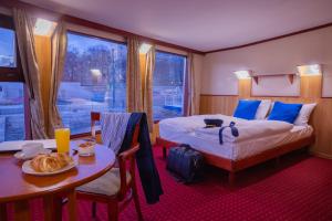 A bed or beds in a room at Fortuna Boat Hotel Budapest