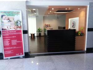 a lobby of a hospital with a sign on the wall at Sara Hotel Apartments in Ajman 