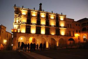 a group of people standing in front of a building at Apartamento Turistico La Victoria in Trujillo