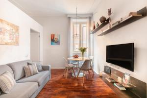 a living room with a couch and a table at Living RHome - Condotti Apartment in Rome