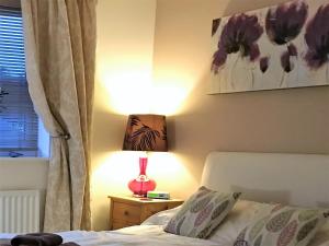 A bed or beds in a room at Abodes B&B 