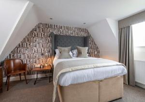 A bed or beds in a room at The Lovat, Loch Ness 