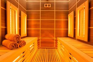 a sauna with two towels sitting on a wooden bench at Hotel Orlovetz in Pamporovo