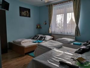 a living room with two beds and a window at Otello in Dukla