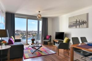 a living room with a view of a city at Fraser Place Canary Wharf in London