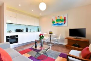 a living room with a couch and a table at Fraser Place Canary Wharf in London