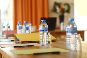 two bottles of water sitting on top of a table at Vacancéole - Domaine du Green in Rivières +51 photos
