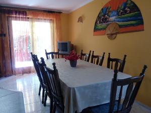 a dining room table with a vase of flowers on it at Üttörő út 177 B in Balatonfenyves