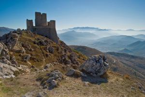 a castle on the top of a mountain at Da Marzia apartment in LʼAquila