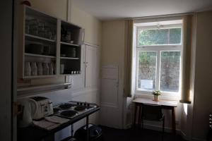 a kitchen with a stove and a window at Newbrough Bunkhouse in Hexham