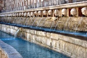 a stone wall with water running down it at Da Marzia apartment in LʼAquila
