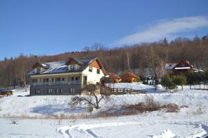 a large house in a snow covered field at DobraNocka in Małastów