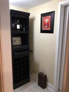 a black book shelf in a corner of a room at Elegant Jewel in Lithonia