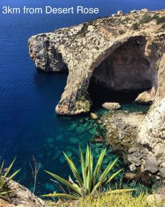 an arch in the rocks in the water at Desert Rose Quiet house 3km away from airport in Safi