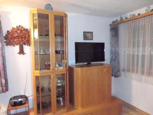 a wooden entertainment center with a television in a living room at Schweiz ,Lenk Ferienwohnung,Kinderfreundl,Seniorenfreundlich in Lenk