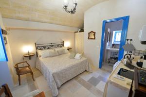 a bedroom with a bed and a desk with a computer at Masseria Oreglia in Ceglie Messapica