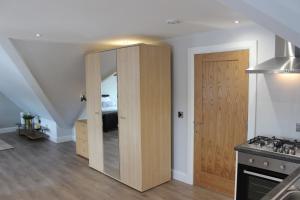 a kitchen with a sliding door and a bedroom at Lakeside Studio 2 Loft Apartment in Enniskillen +6 photos