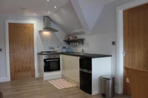 a kitchen with a sink and a stove at Lakeside Studio 2 Loft Apartment in Enniskillen