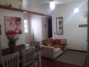 a living room with a couch and a table at Capão 2 Dormitorios in Capão da Canoa