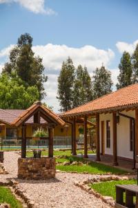 a building with wooden pavilions in a park at Hotel El Molino in Santa Cruz