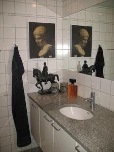 a bathroom with a sink and a mirror at Esben Juhls Guest Room in Copenhagen