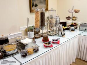 a kitchen counter filled with lots of different types of food at Paliria Hotel in Chalkida