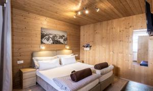 a bedroom with a bed in a wooden wall at SkiLodge Seppaler in Sankt Anton am Arlberg