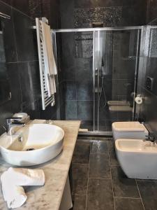 a bathroom with two sinks and a shower at Via Veneto Suites in Rome