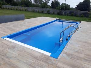 a large blue swimming pool on a patio at Trippr Chikkamagaluru in Chikmagalūr