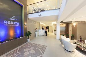 a lobby of a hotel with a large sign on the wall at Agusta Spa Hotel in Veliko Tŭrnovo