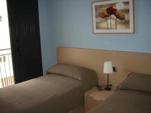 A bed or beds in a room at Apartamentos San Cristobal