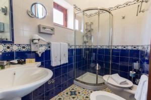 a bathroom with a sink, toilet and bathtub at Hotel Eros in Vulcano