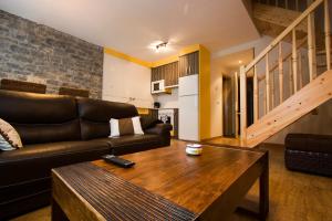 a living room with a couch and a coffee table at Apartamentos Cañardo Autural in Orós Alto