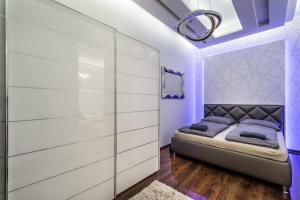 a bedroom with purple walls and a bed with a mirror at Amora Homes Breathless view Parliament 2 Luxury Suites with terrace FREE PARKING RESERVATION NEEDED in Budapest