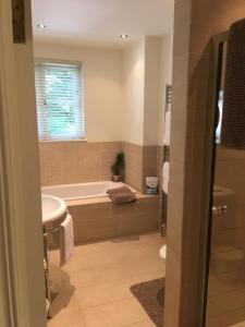 a bathroom with a tub and a sink at Gweebarra in Holywood