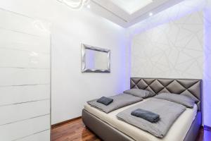 a bedroom with a bed with purple lighting at Amora Homes Breathless view Parliament 2 Luxury Suites with terrace FREE PARKING RESERVATION NEEDED in Budapest +55 photos