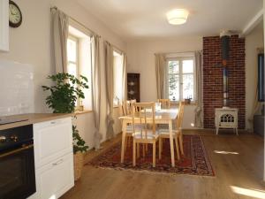 a kitchen and dining room with a table and chairs at Olivia House in Abertamy