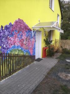 a building with a colorful mural on the side of it at Penzion Krásný Dvůr in Krásný Dvŭr