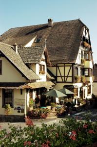 a large white building with a brown roof at Résidence des Châteaux in Ottrott