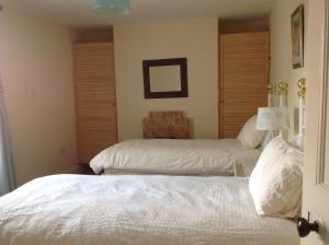 a bedroom with two beds and a lamp in it at Cricket View cottage in Redcar