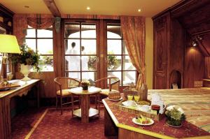 a bedroom with a bed and a table with food on it at Résidence des Châteaux in Ottrott