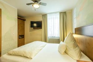 Postel nebo postele na pokoji v ubytování Hotel Brunner